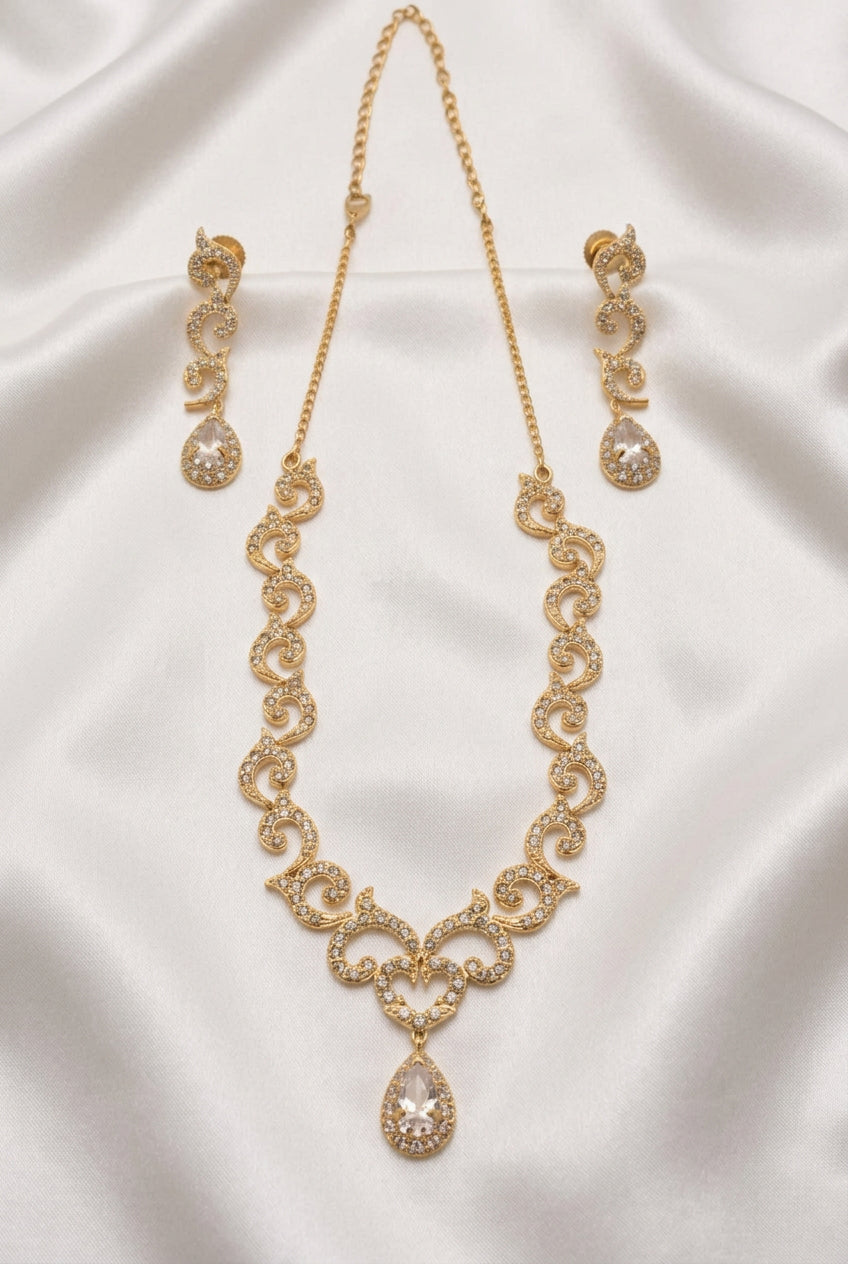 Gold necklace with intricate design on a beige background