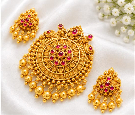 Intricate traditional round pendant with green and red stones (ruby and emerald colored), paired with matching jhumka-style drop earrings.