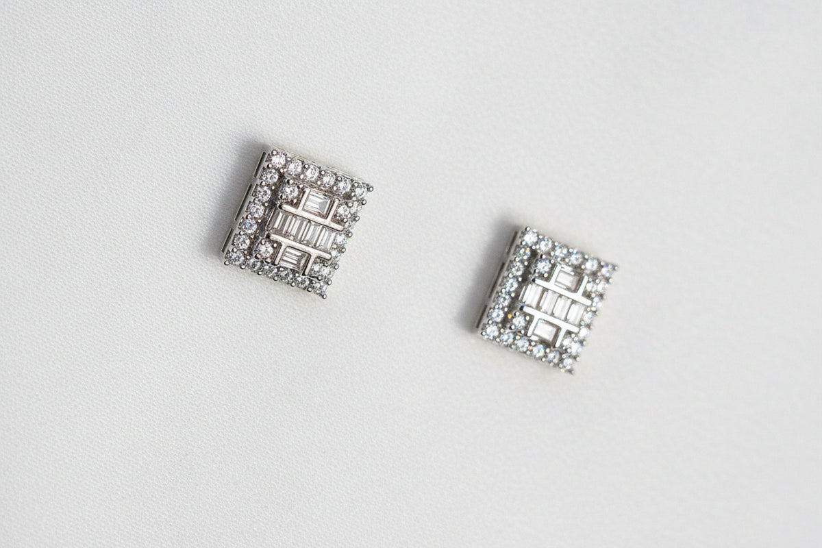Pair of square crystal earrings on a black background