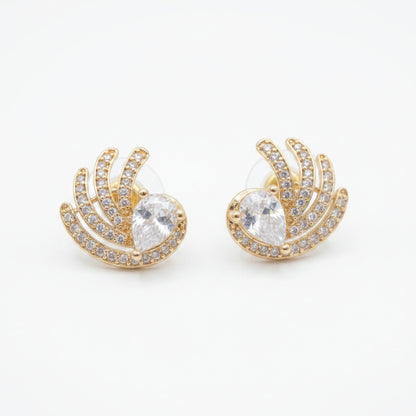 A pair of gold crescent-shaped stud earrings with a central clear teardrop gemstone and surrounding pavé-set clear stones, shown on a plain white background.