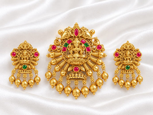 Traditional Gold Tone Lakshmi Pendant Set with Ruby Green Stones and Matching Temple Earrings