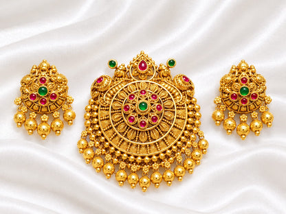 Intricate traditional round pendant with green and red stones (ruby and emerald colored), paired with matching jhumka-style drop earrings.
