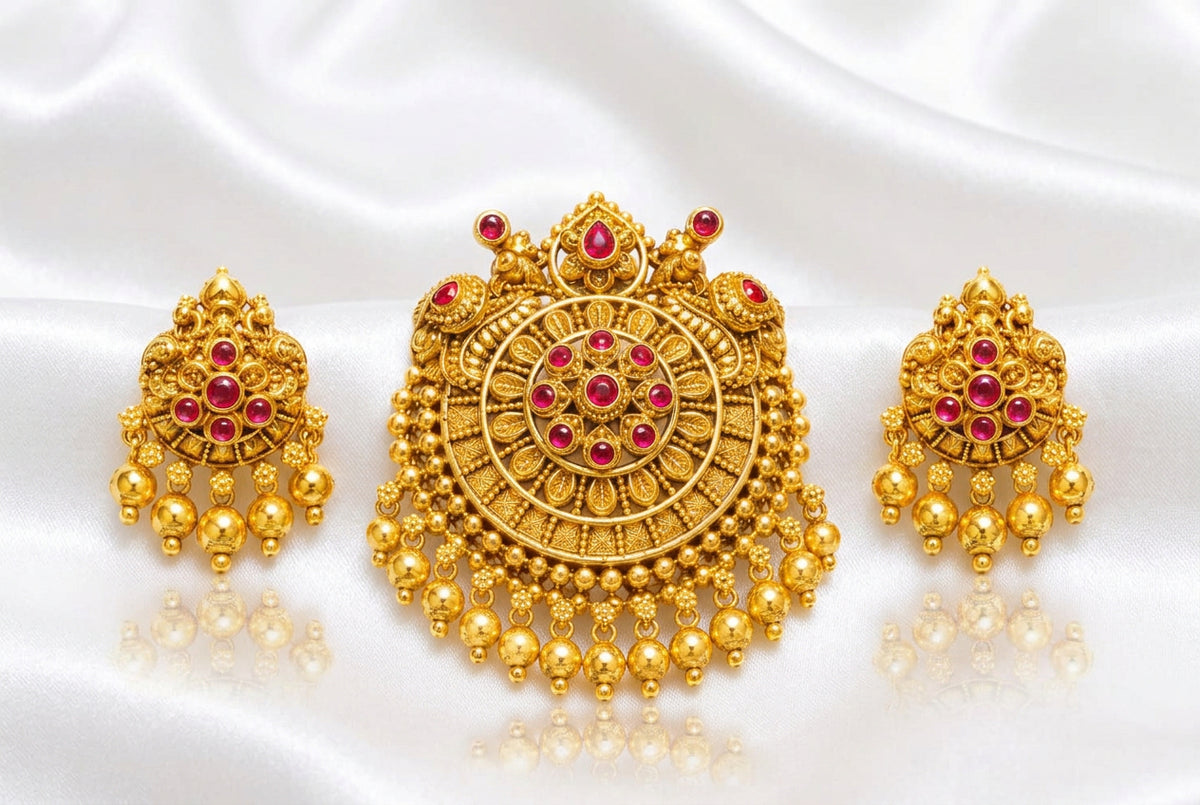 Intricate traditional round pendant with green and red stones (ruby and emerald colored), paired with matching jhumka-style drop earrings.