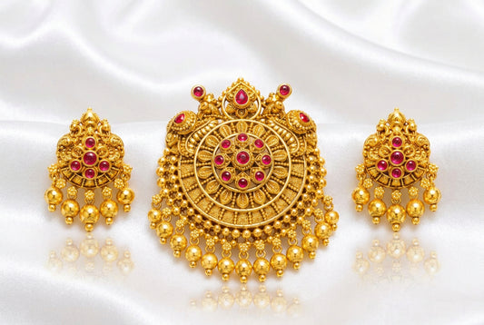 Intricate traditional round pendant with green and red stones (ruby and emerald colored), paired with matching jhumka-style drop earrings.