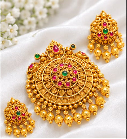 Intricate traditional round pendant with green and red stones (ruby and emerald colored), paired with matching jhumka-style drop earrings.